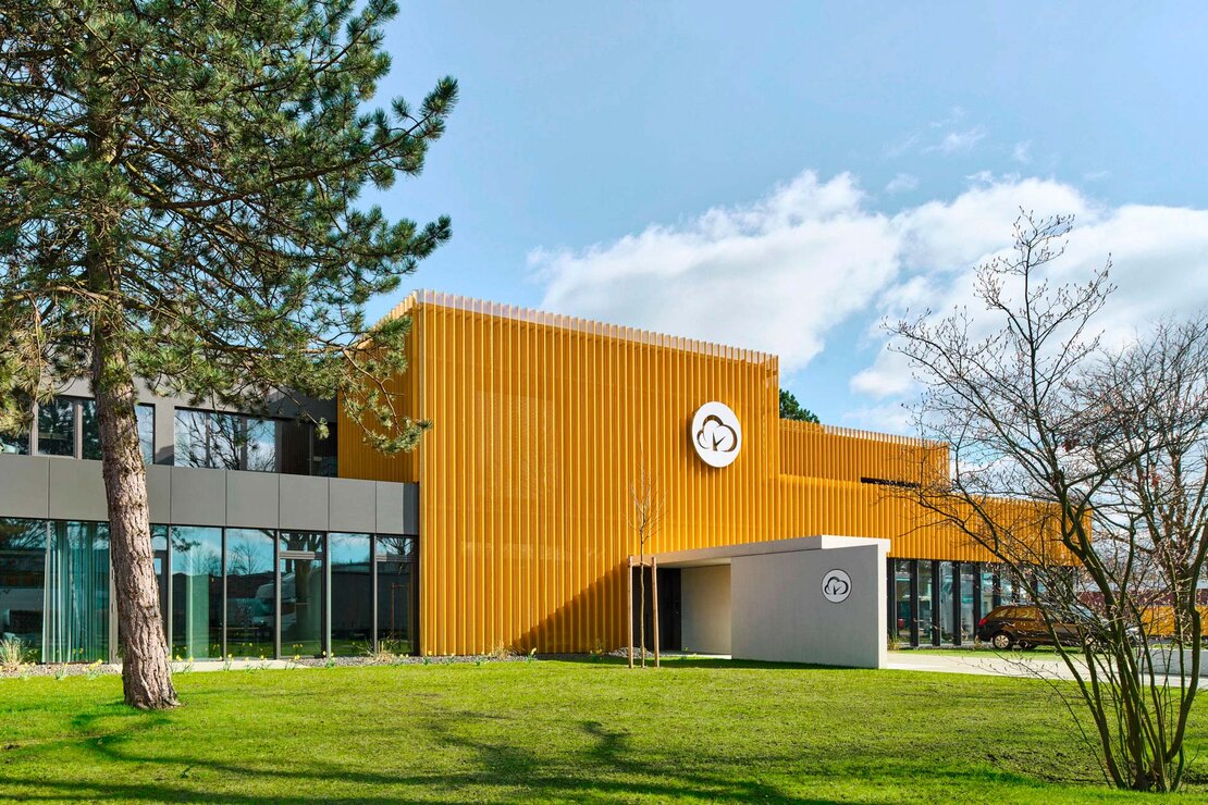 Produktionshalle und Bürogebäude in Gütersloh mit gelber Aluminium Trapezprofilfassade