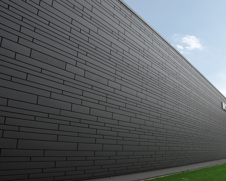 Referenz-Projekt mit Siding Plus im Farbton „matt-de-luxe” grey 207 mit versetzten Stößen und verschiedene Baubreiten